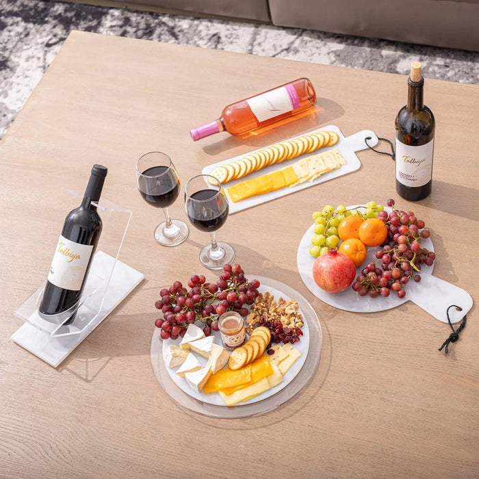 Flat marble charcuterie board displaying cheese, cured meats, grapes, and wine for entertaining and serving appetizers.