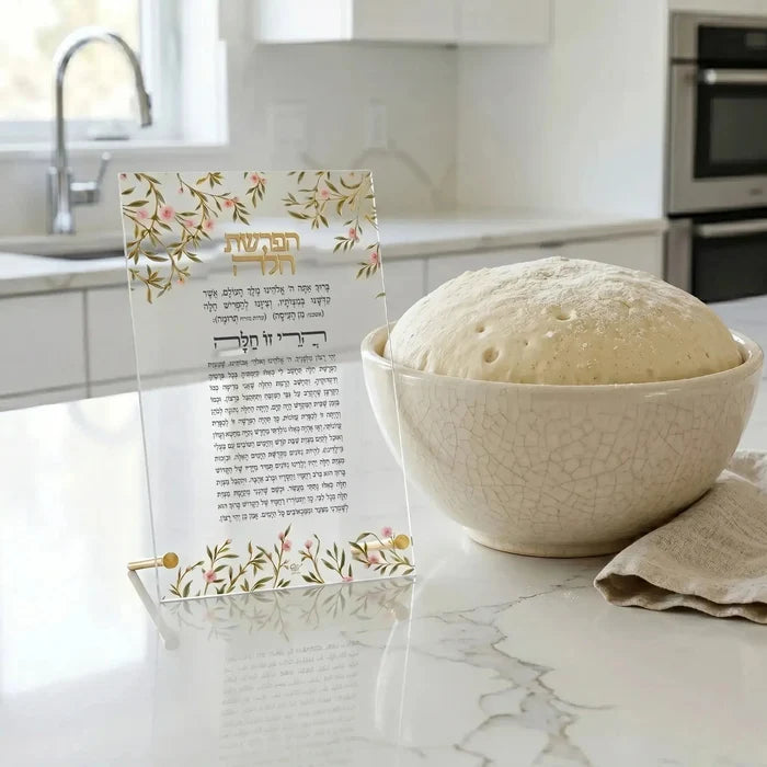 Floral Bird Challah plaque in cream ceramic with gold accents displayed on kitchen counter next to fresh challah bread.