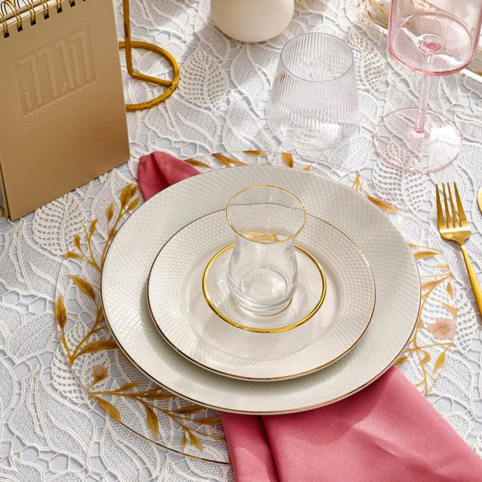 Floral Bird Chargers in cream displayed on white dinnerware with gold accents and pink napkin for elegant table setting.