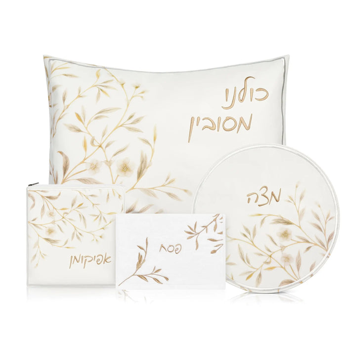 Floral Bird Pesach Set in gold and white featuring matching placemats, napkins, and decorative plates with leaf design