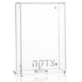 Clear glass Frame Tzedakah Box by Waterdale Collection, modern rectangular design with silver accents, displayed on reflective surface.