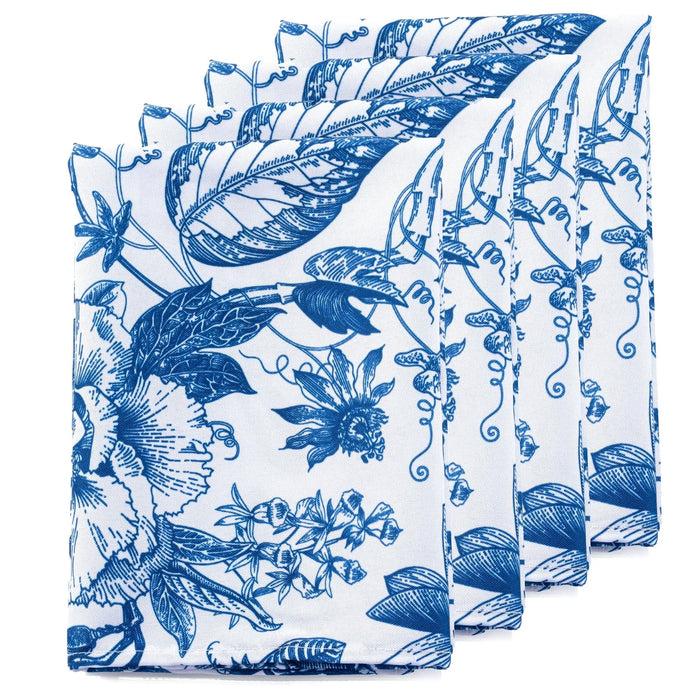 Stack of blue and white French toile napkins featuring botanical bird and floral patterns from Waterdale Collection