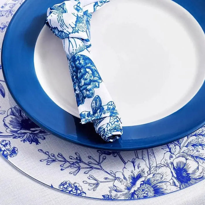 Blue and white French toile napkin with floral pattern, displayed on matching plate with coordinating napkin ring from Waterdale Collection.