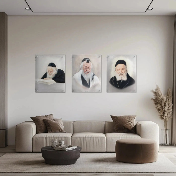 Three portrait prints of revered Jewish scholars displayed on a neutral wall above a beige sectional sofa with decorative pillows and round ottoman.