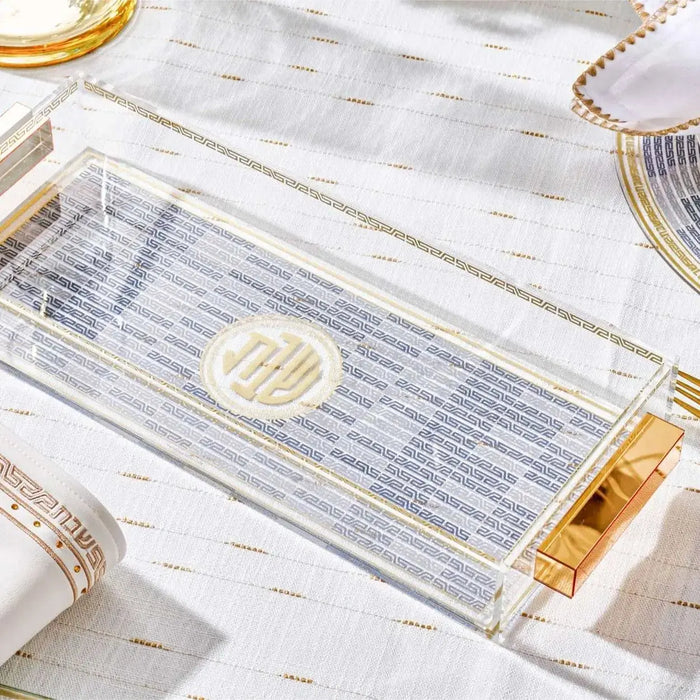 Geometric bread tray with blue striped pattern and gold accents, displayed with tableware and linens on white surface.