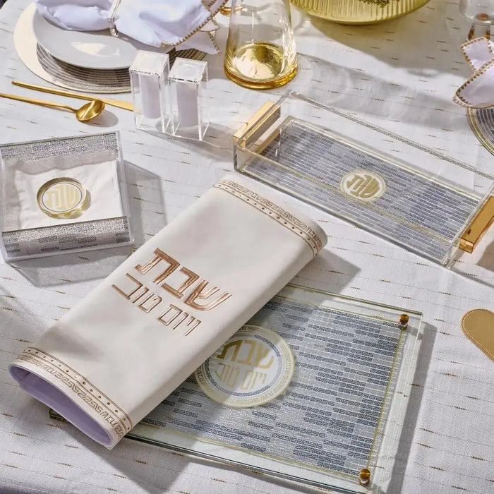 Waterdale Collection geometric challah board and cover set in white with gold accents, displayed on a table setting.