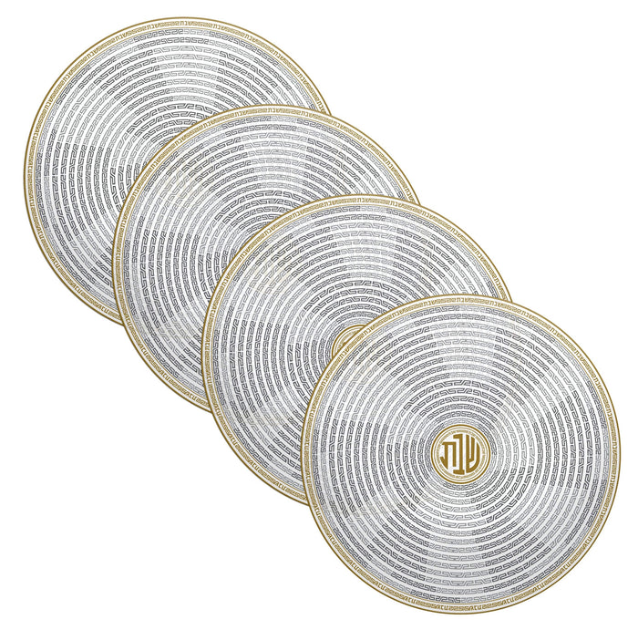 Set of four geometric chargers with concentric circular patterns in gold and white, perfect for elegant table settings and holiday entertaining.