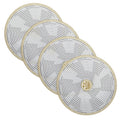 Set of four geometric chargers with concentric circular patterns in gold and white, perfect for elegant table settings and holiday entertaining.