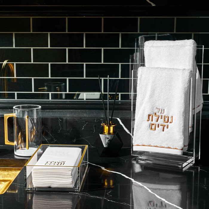 Black geometric diffuser by Waterdale Collection displayed on marble surface with product packaging and accessories in modern home setting.
