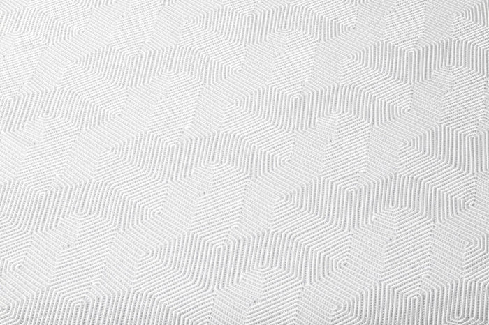 White geometric tablecloth with raised diamond pattern texture, perfect for Shabbat and Pesach dining from Waterdale Collection.