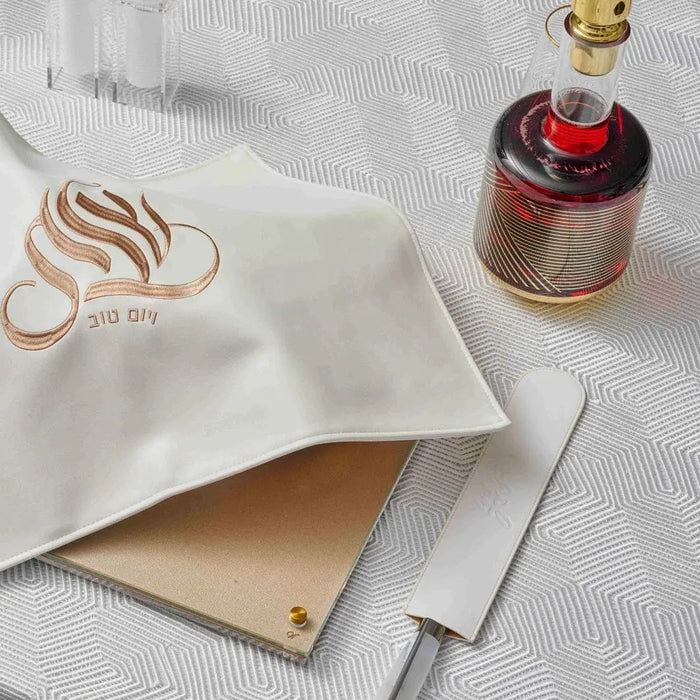 Cream geometric tablecloth with striped pattern, displayed flat with perfume bottle and gold accessories on white background