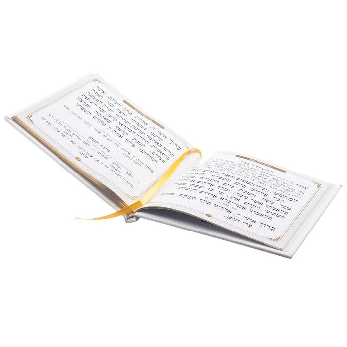 Hardcover leather bencher set with gold accents, open pages showing Hebrew text, cream and gold colored binding with ribbon bookmark.