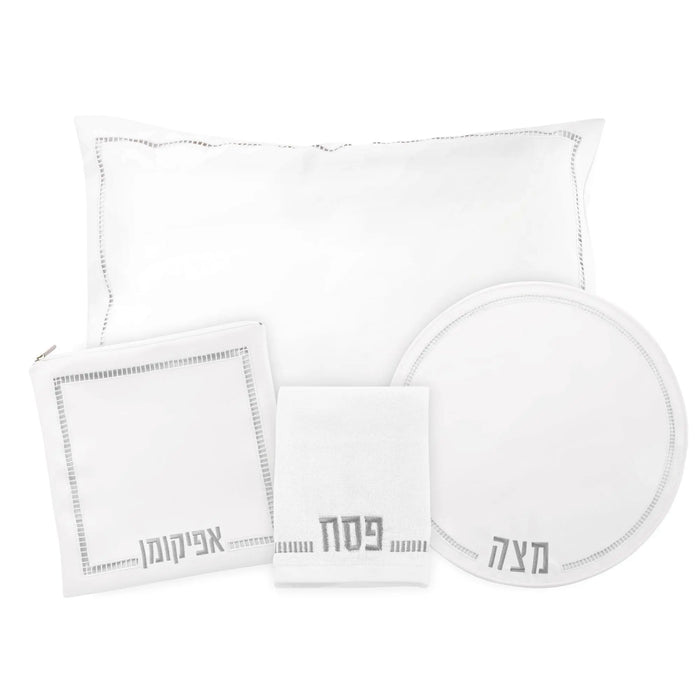 Hemstitched Pesach set with white linens including a matzah cover, napkins, and round plate with decorative borders.