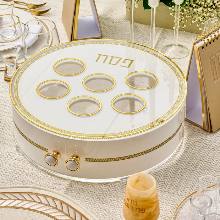 Herringbone 3 Level Seder Plate with gold trim and lucite construction, displayed on a holiday Passover table setting with place settings and glassware.