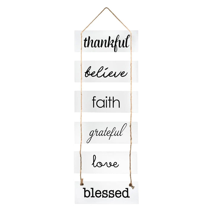 Wooden home sign with stacked text reading "thankful, believe, faith, grateful, love, blessed" in black lettering.