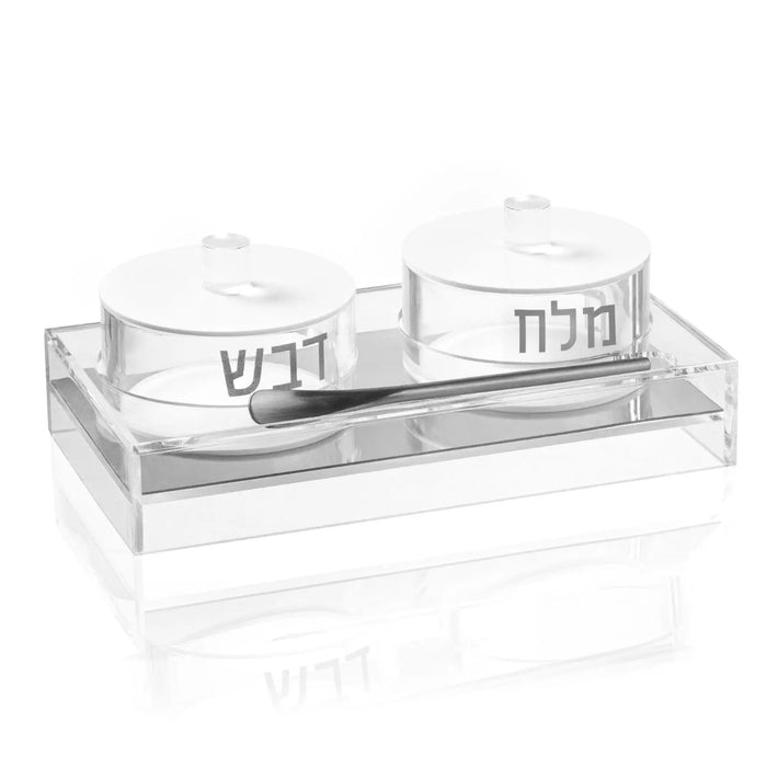 Two Lucite bowls labeled דבש and מלח for honey and salt at the Jewish New Year table