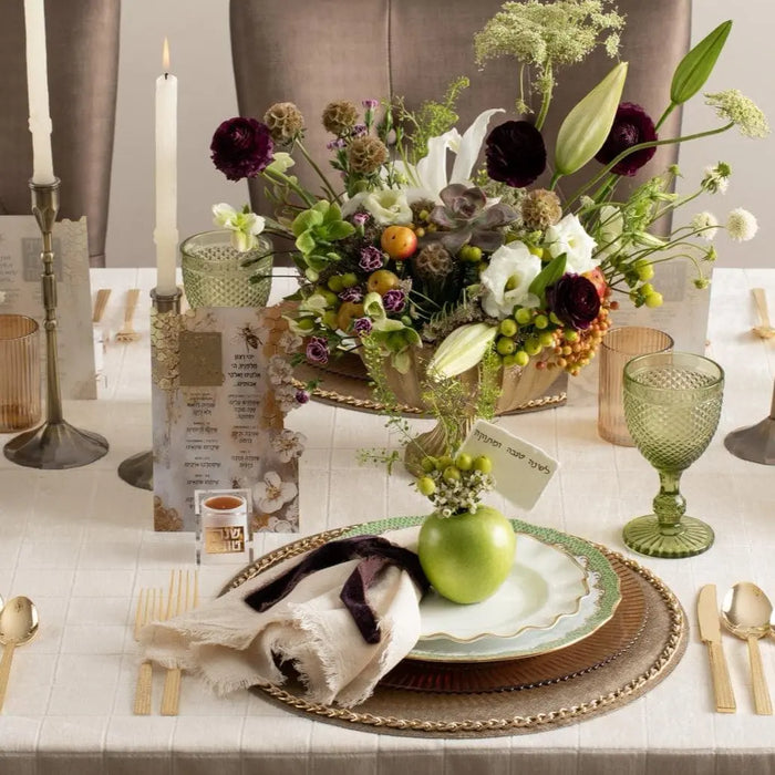 Honeycomb simanim card alongside a personal suspended honey dish on a Rosh Hashonah place setting