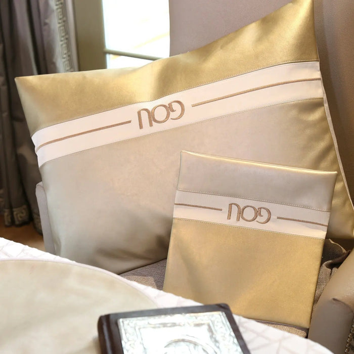 Horizontal Pesach Set in gold and white leather from Waterdale Collection, displayed with packaging on table.