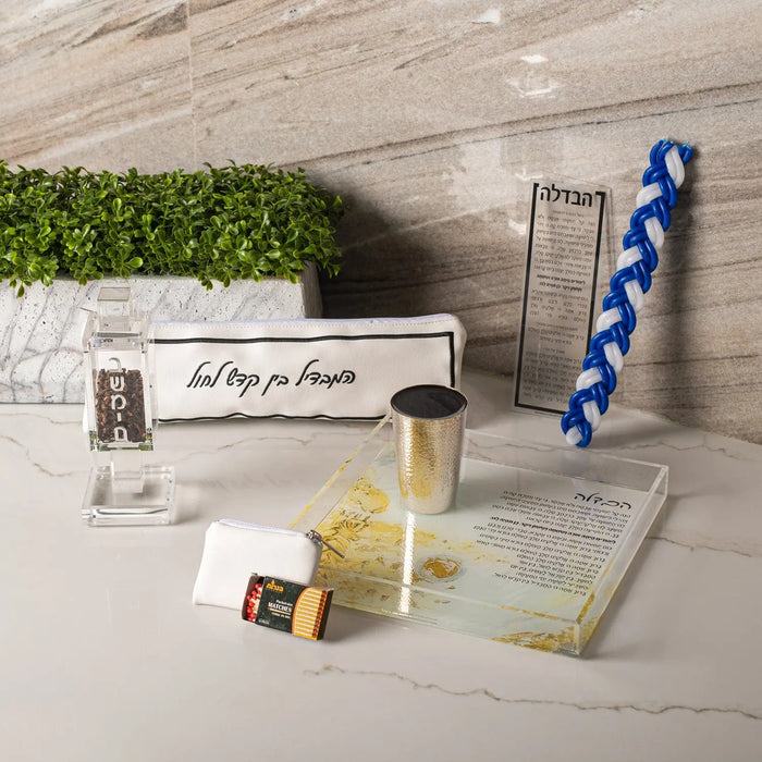 Hotel Style Havdalah Set by Waterdale Collection featuring brass candleholder, spice box, and blue twisted candle on white marble base with leather accents