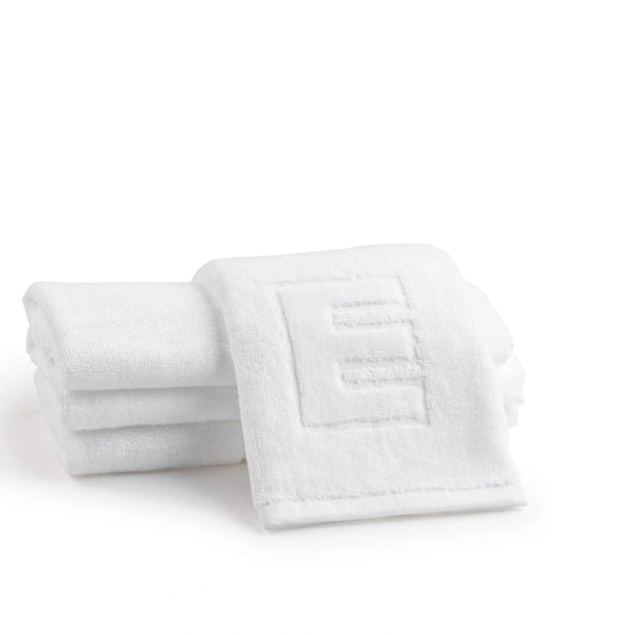 Stack of white embossed finger towels with monogrammed initial design, folded display shot showing soft cotton material and textured pattern detail.