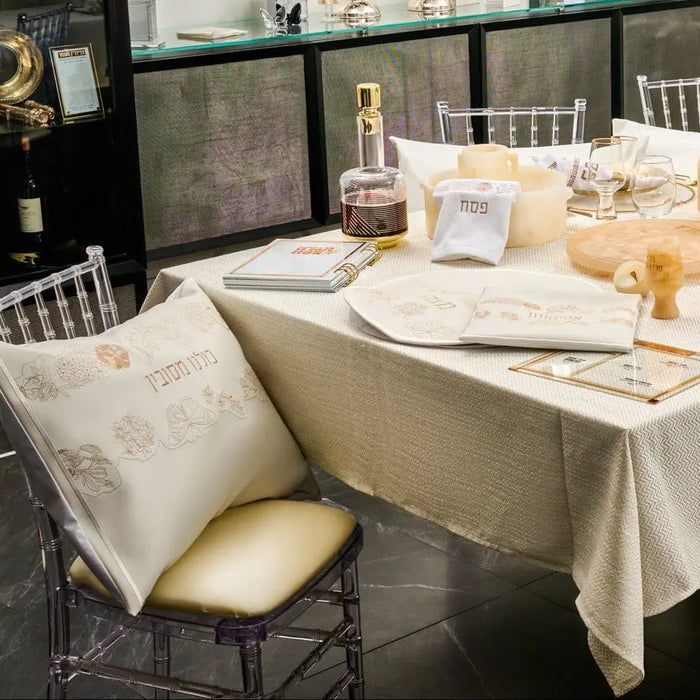 Waterdale Collection Inlay Floral Pesach Set with white and gold leather placemats and napkins arranged on dining table