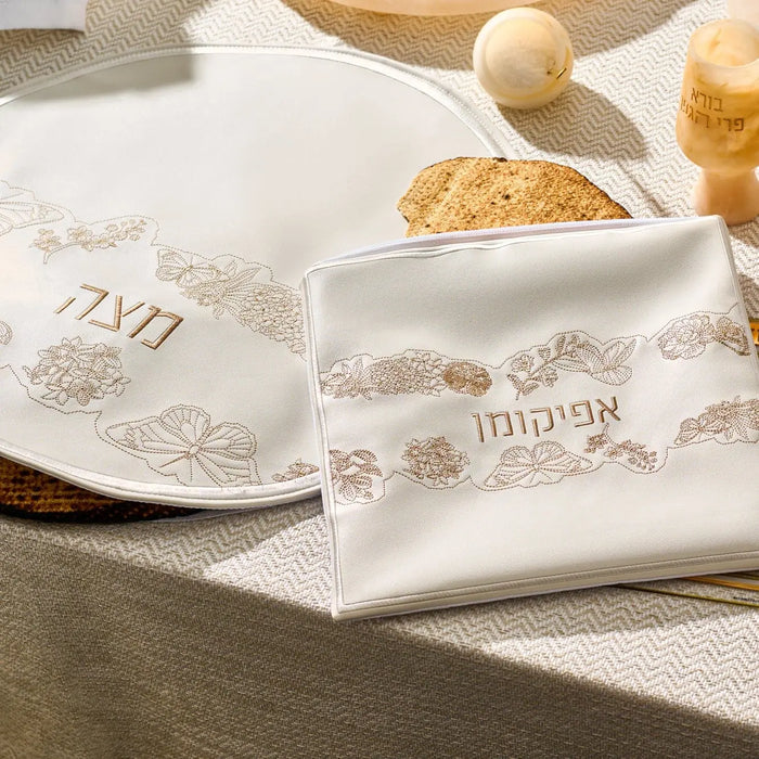 Inlay Floral Pesach Set in gold and white leather with matching plate and matzah cover on table setting
