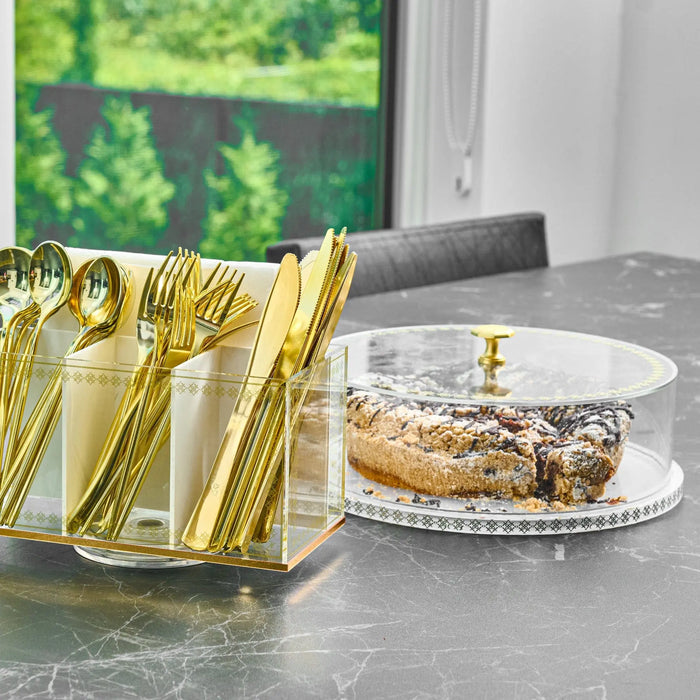 Clear glass cake dome with gold-trimmed base on marble counter, displaying pastry inside, perfect for serving and storage.