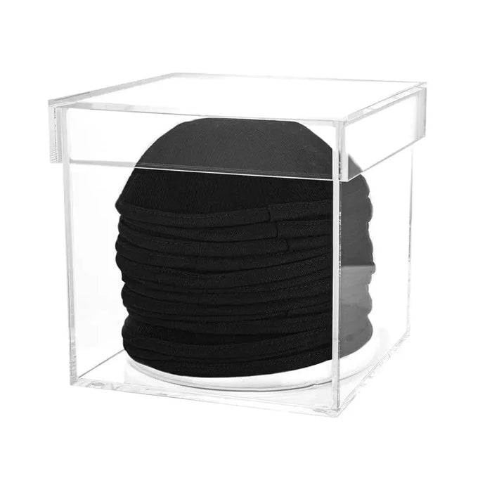 Black Kippah Keeper storage container holding stacked black kippahs, clear acrylic case for organized Jewish head covering storage.