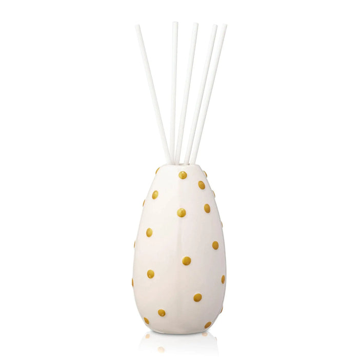 KS Gold Diffuser with white ceramic base and gold polka dot pattern, featuring reed sticks for room fragrance diffusion.
