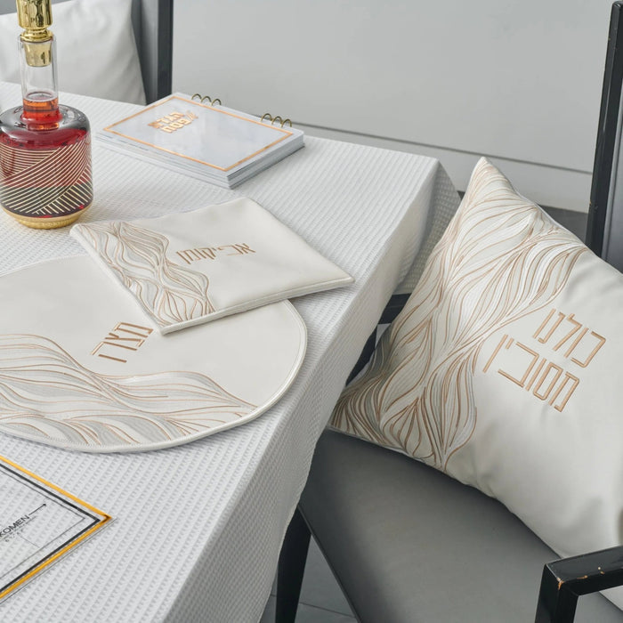 Lace Pesach set with gold and white placemats and napkins arranged on table with plate and tableware