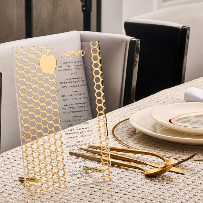 Gold laser-cut simanim (סימנים) tabletop on a Rosh Hashana place setting