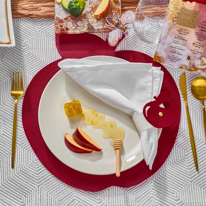 Gold apple napkin wraps with apple chargers on a Rosh Hashanah tablescape