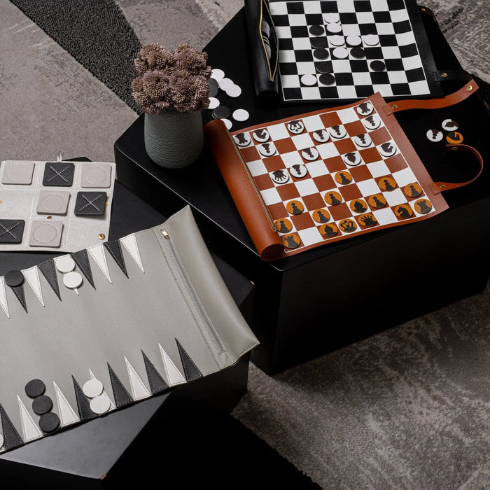 Waterdale leather chess and checkers set with brown and white board displayed on black storage box, featuring classic game pieces and accessories.