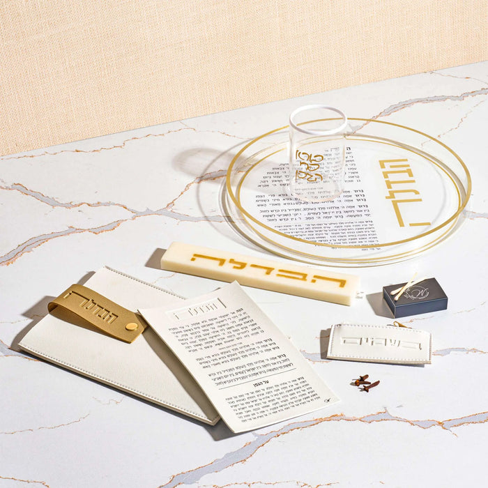 Leather Havdalah set displayed with gold-rimmed plate, candle holder, spice box, and blessing cup on marble surface, complete bundle by Waterdale Collection.