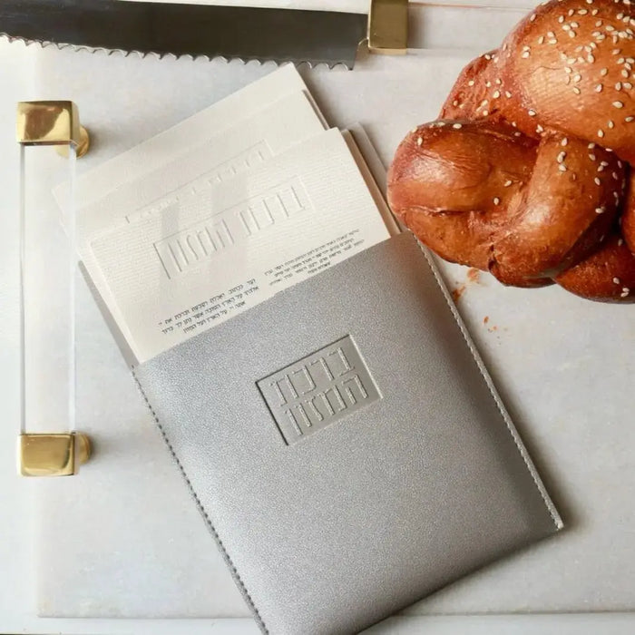 Beige leather magnetic bencher set by Waterdale Collection displayed with challah and gold accents on white surface
