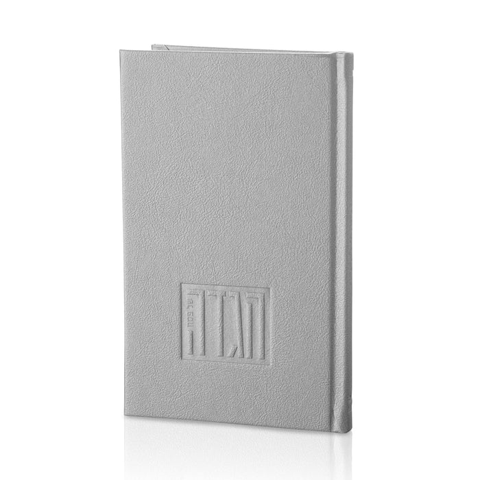 Gray leather painted Haggadah with embossed cover design, standing upright displaying the front cover of this Pesach prayer book.
