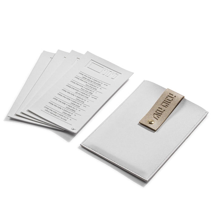 White leatherette Simanim pouch with Shana Tova lettering from Waterdale Collection, open with the leather cards