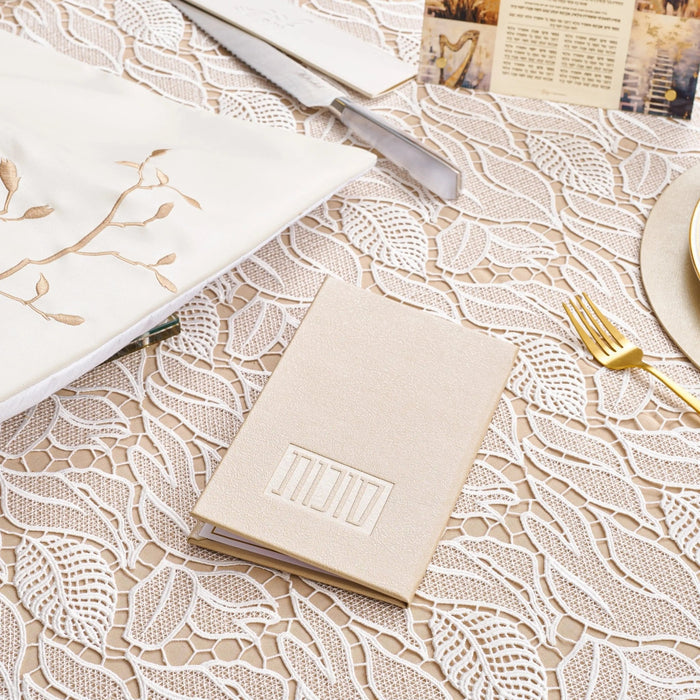 Leather Sukkos booklet on a set sukkah table, Sukkos bencher booklet for Sukkot (סוכות)
