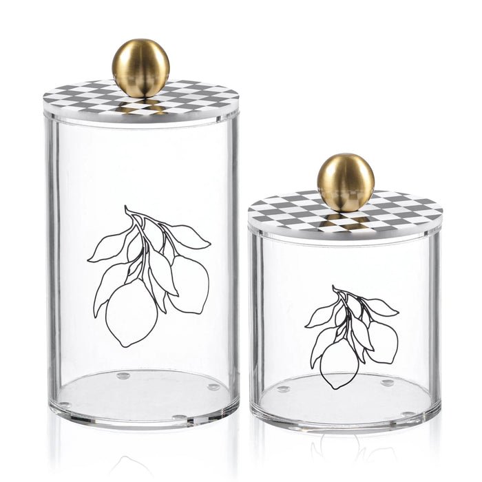 Two clear glass Lemona Cylinder Canisters with lemon branch etchings and brass finials in different sizes for kitchen storage.