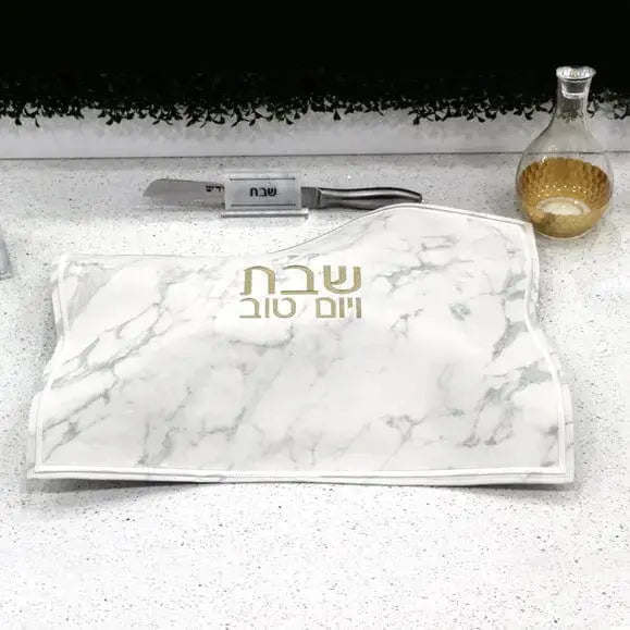 Marble Challah Board and Cover Set from Waterdale Collection displayed with gold Shabbat candle and prayer book on white surface