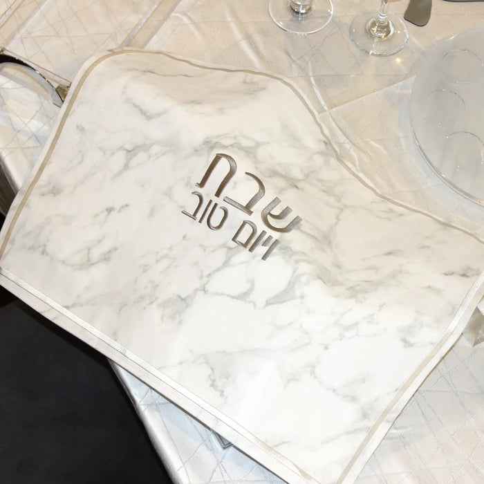 Marble challah cover in white and gray leather with gold embroidered details for Shabbat table.