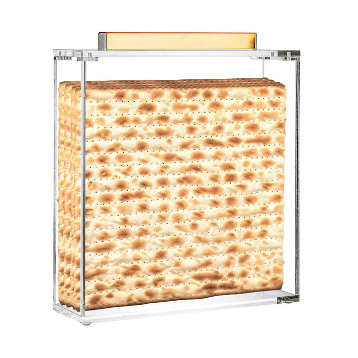 MetaLucite Square Matzah Box with gold metal frame and lucite sides displaying matzah inside, modern Pesach tabletop storage.