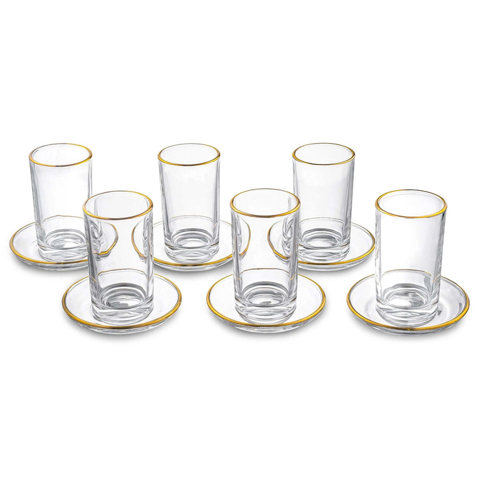 Set of six modern glass kiddush cups with matching saucers, featuring clear glass and gold-tone rim details from Waterdale Collection.