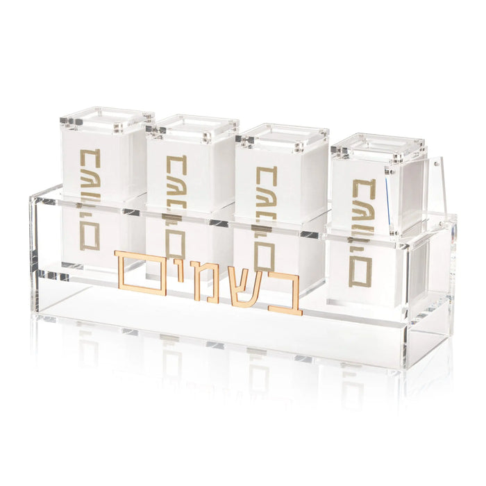 Four clear glass suspended besamim jars from Waterdale Collection arranged in a row, featuring gold-tone metal holders and decorative designs, ideal for Shabbat and entertaining.
