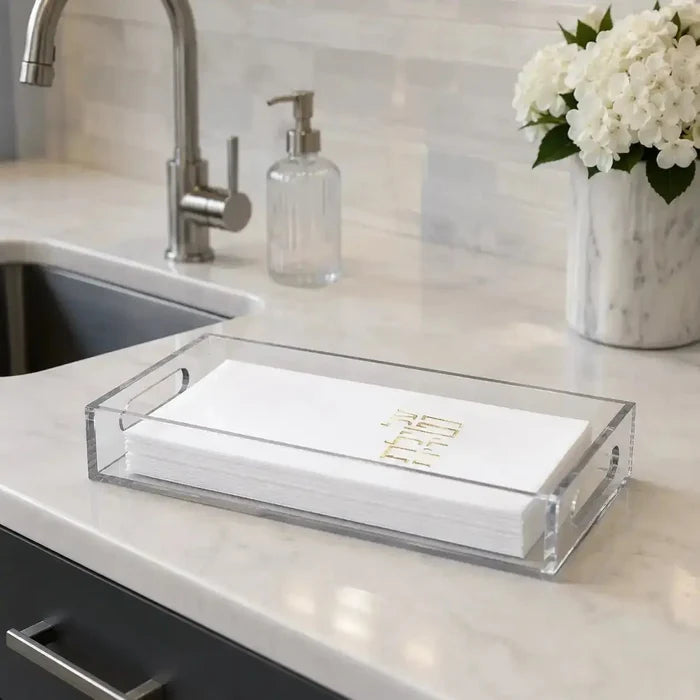Netilas yadayim guest towelettes folded in a tray beside the washing sink, disposable hand towels