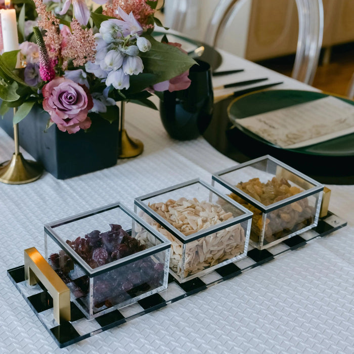 Onyx 3 Sectional Dip Bowl Set with black marble compartments on gold stand, displayed with appetizers at a table setting.