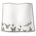 Onyx Butterfly Challah Cover with delicate butterfly and floral embroidery detail along the bottom hem in gold and silver tones on white fabric.