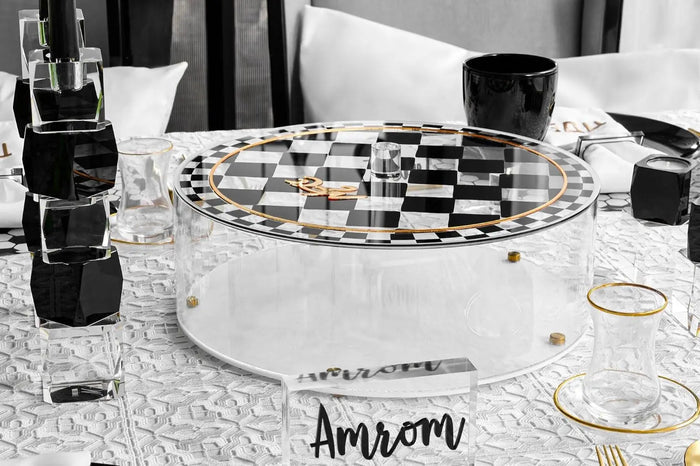 Onyx Matzah Box displayed with Passover tabletop decor, featuring a clear lucite design with black accents and gold holiday accessories.