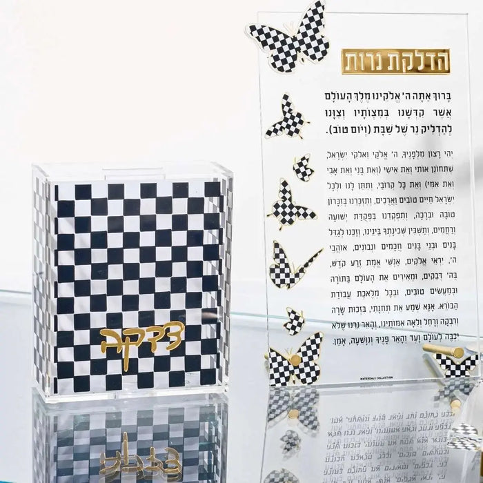 Onyx Tzedakah Box by Waterdale Collection displayed with chess board and pieces, black and white polished stone design for Shabbat and Jewish home decor.