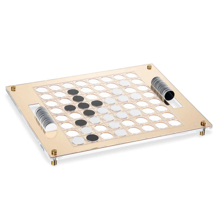 Wooden Othello game board with black and white reversible pieces, featuring natural light wood frame and corner brass accents on clean white background.